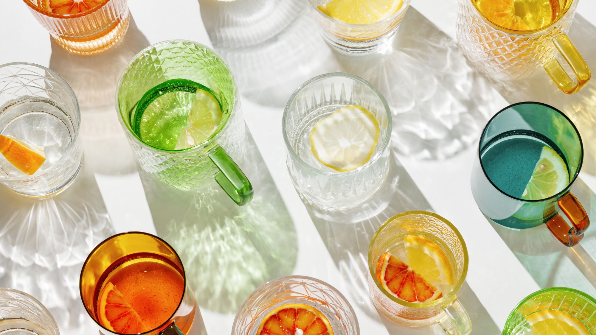 A flat lay of glasses with slices of lemon in them