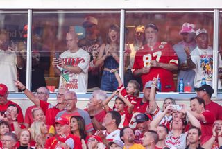 Taylor Swift in the stands at a Chiefs Ravens game wearing a jersey