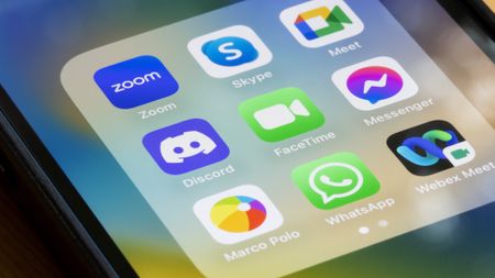 Assorted video chat apps are seen on an iPhone, including Zoom, Skype, Google Meet, Discord, FaceTime, Messenger, Marco Polo, WhatsApp, and Cisco Webex Meetings.