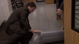 Dwight looking in the garbage can in The Office