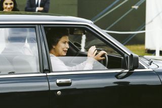 Queen Elizabeth II drives her car away from the Windsor Horse Show in Windsor, Berkshire, UK, 16th May 1982.