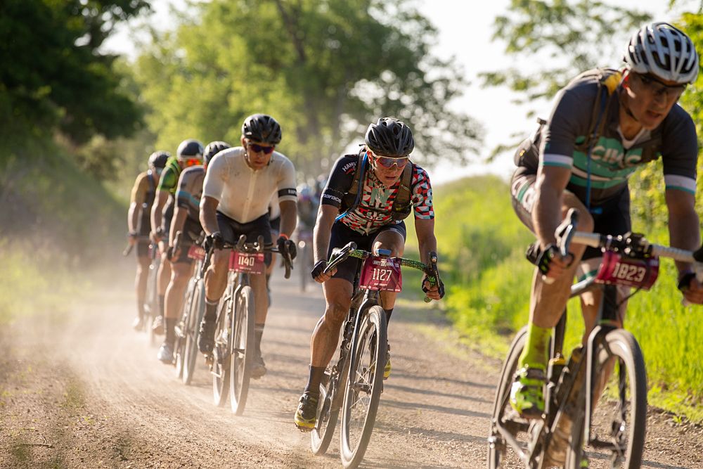 Amy Charity built a lead of more than six minutes in the women's field before mid-race, but a series of flat tires sent her backward in the standings by end of day.