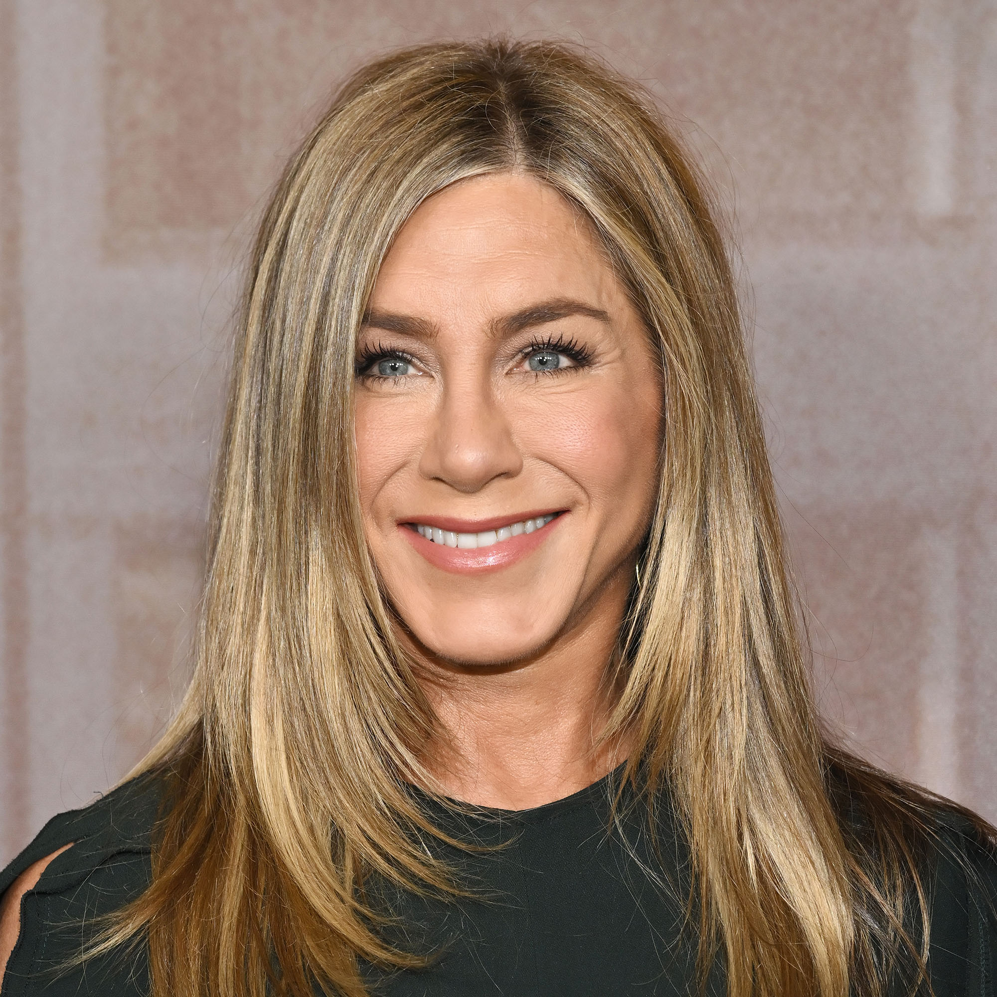 Jennifer Aniston at "The Morning Show" Season 4 Official Emmy FYC Event wearing black stood in front of neutral background