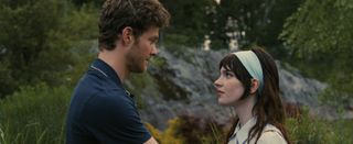 jack quaid as josh and sophie thatcher as iris having a conversation outside of a cabin in the movie companion