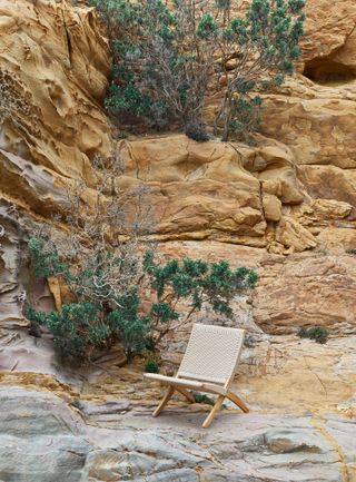 outdoor chair on rocks, photographed by Massimo Vitali