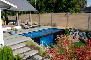 shipping container pool set into wood decking