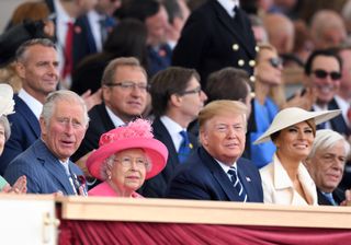 King Charles, Queen Elizabeth, Donald Trump and Melania Trump sitting in a row at a D-Day75 National Commemorative Event in 2019