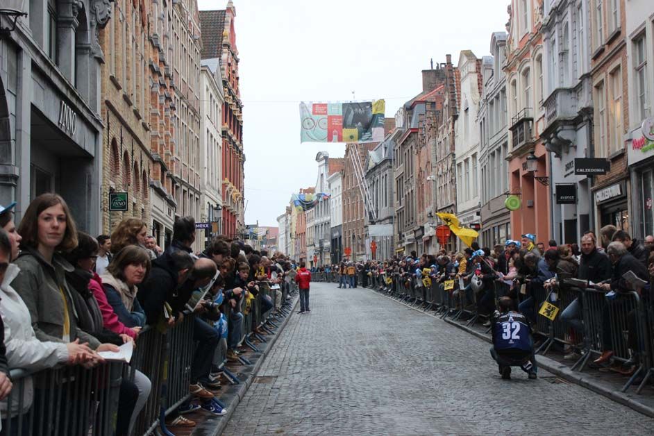 Fans line the road from the team busses to the sign on podium