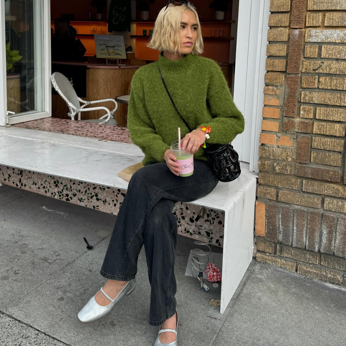 Caitlin wearing black jeans with silver shoes