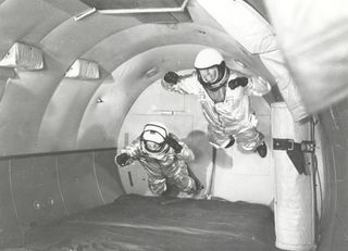 Astronauts in the C-131 "vomit comet" simulate weightless flight.