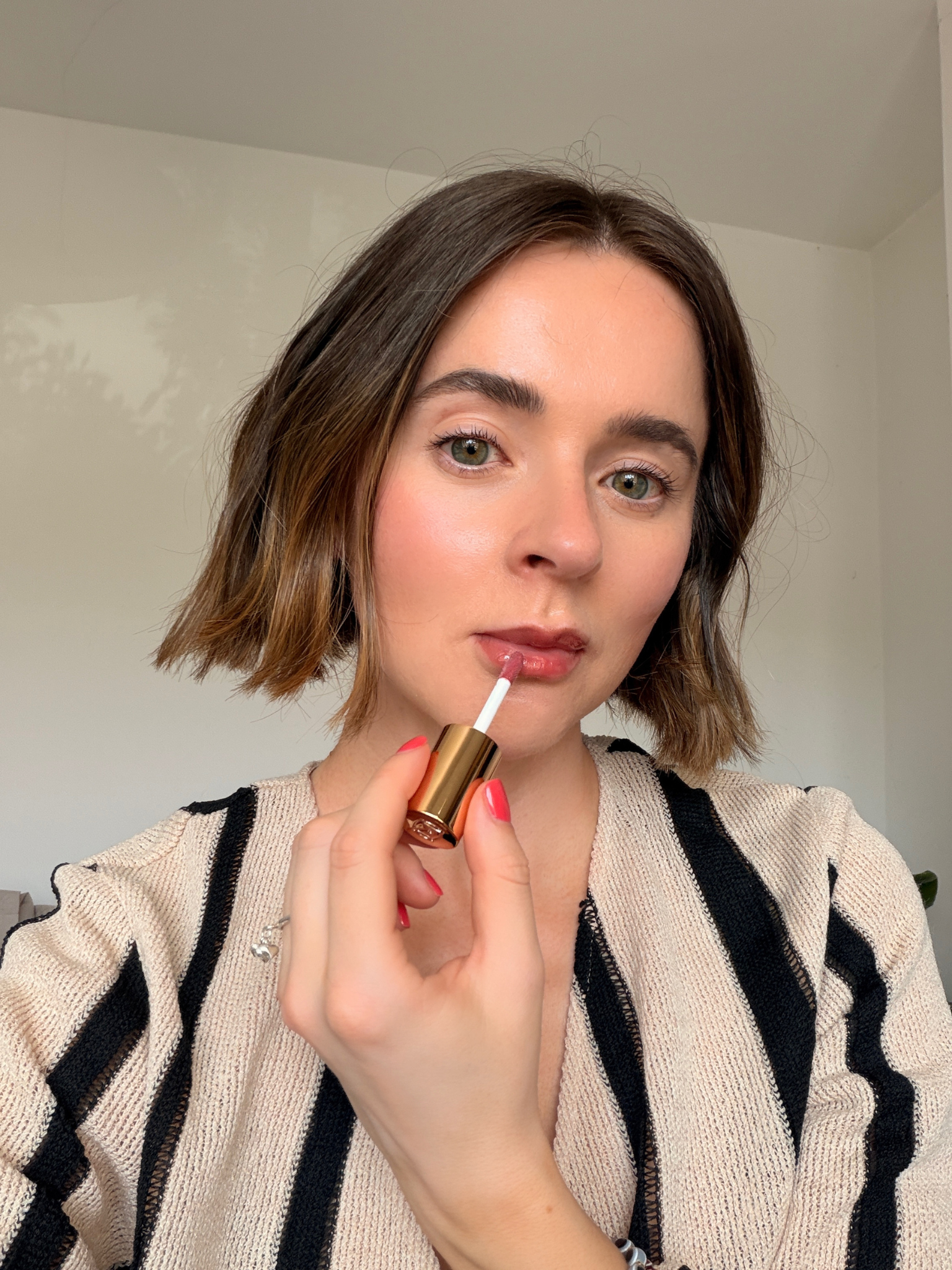 Grace applying the Merit lip gloss