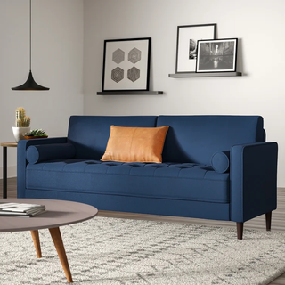 Blue sofa with bolster cushions