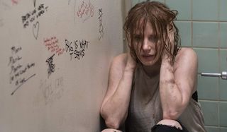 IT Chapter Two Jessica Chastain huddled, hands over her ears, in a bathroom stall