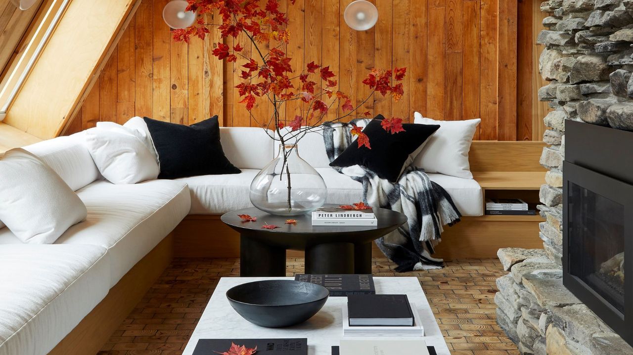 living room with wood panelling on walls and white corner sofa