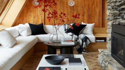 living room with wood panelling on walls and white corner sofa