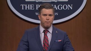 Colin Jost gives a press conference as Pete Hegseth on SNL.