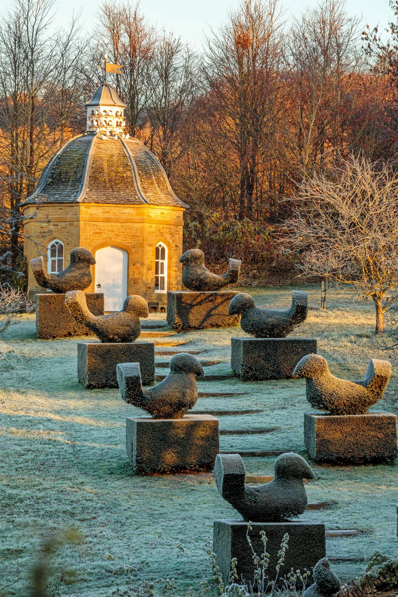 The dovecote and its topiaried inhabitants. Rockcliffe garden, Gloucestershire, photgraphed by Clive Nichols.