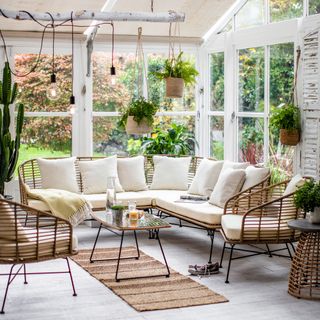 garden room with white cushion armchair and coffee table