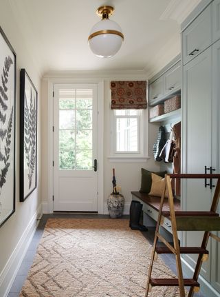 Entryway mudroom painted in a tasteful palette of cool colors