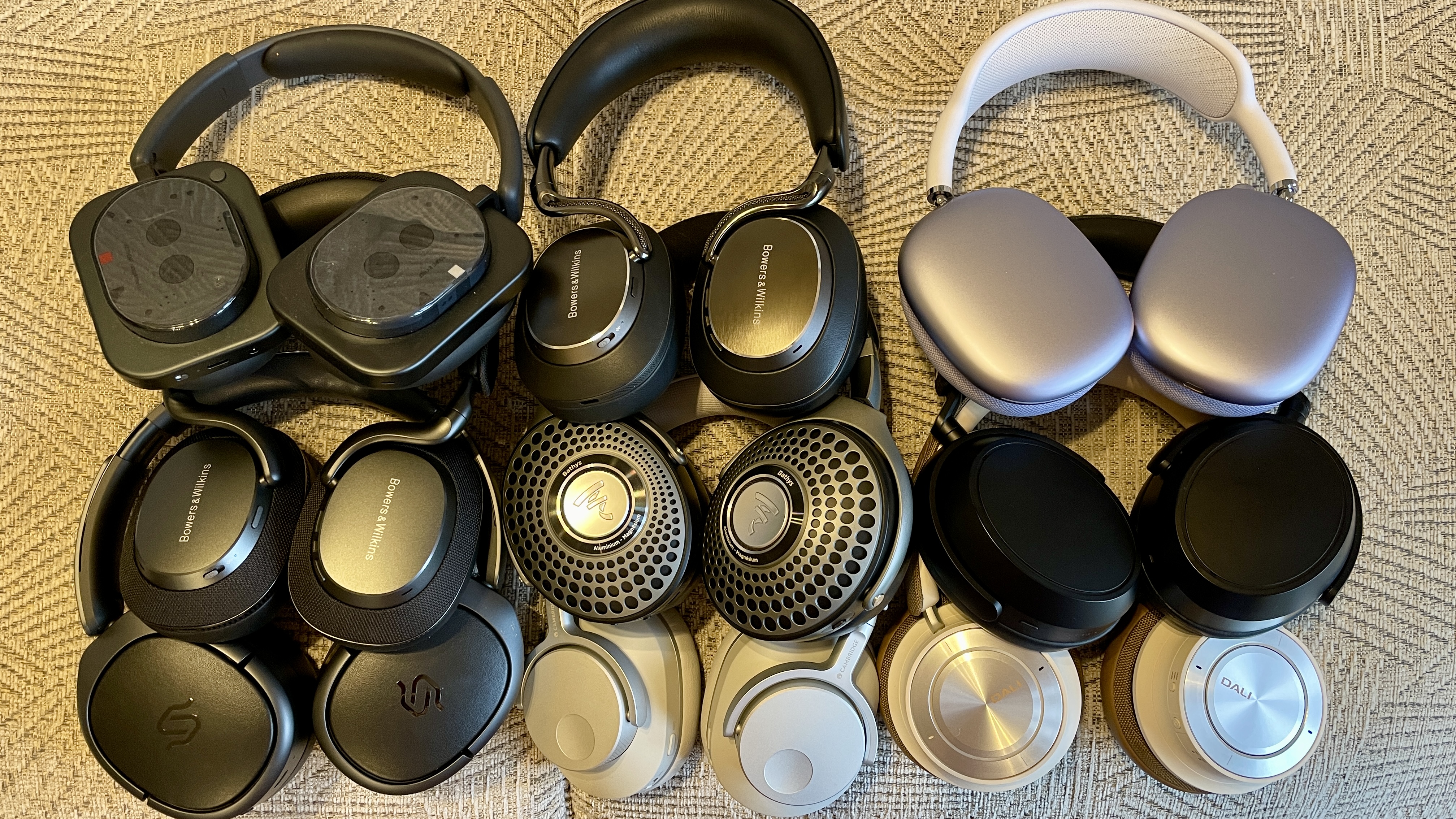 A selection of headphones on a fabric tablecloth 