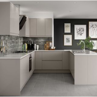 kitchen with grey floor tiles and wall tiles, dark grey wall with gallery wall and cashmere cabinets