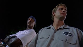 Paul Walker and Tyrese Gibson standing next to each other in 2 Fast 2 Furious