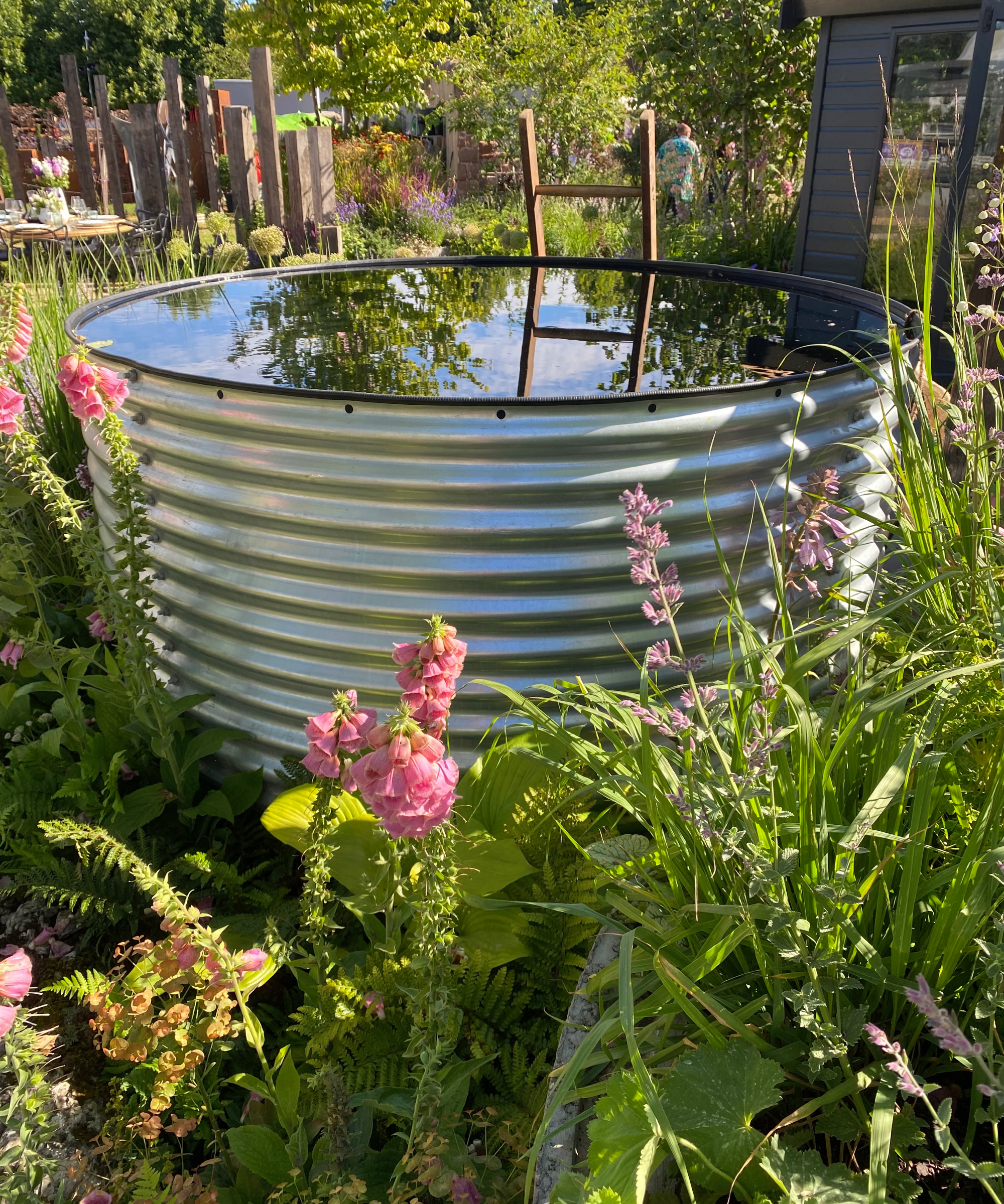 metal stock tank swimming pool in well planted garden