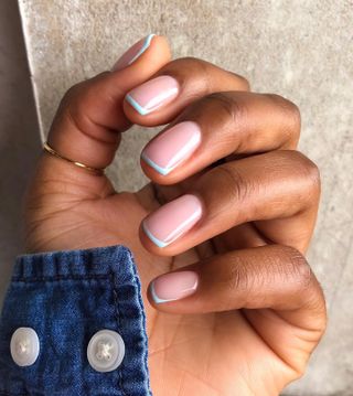 a blue French tip manicure