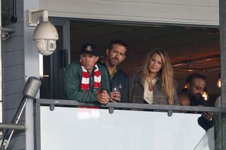 Wrexham owners Rob McElhenney watch the game with Ryan Reynolds and his wife Blake Lively during the Vanarama National League match between Wrexham and York City at the Racecourse Ground