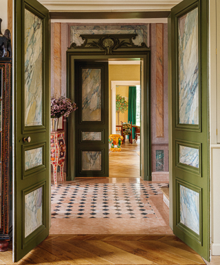 hallway of grand french 20th century mansion with lots of plaster detail and coloured marble