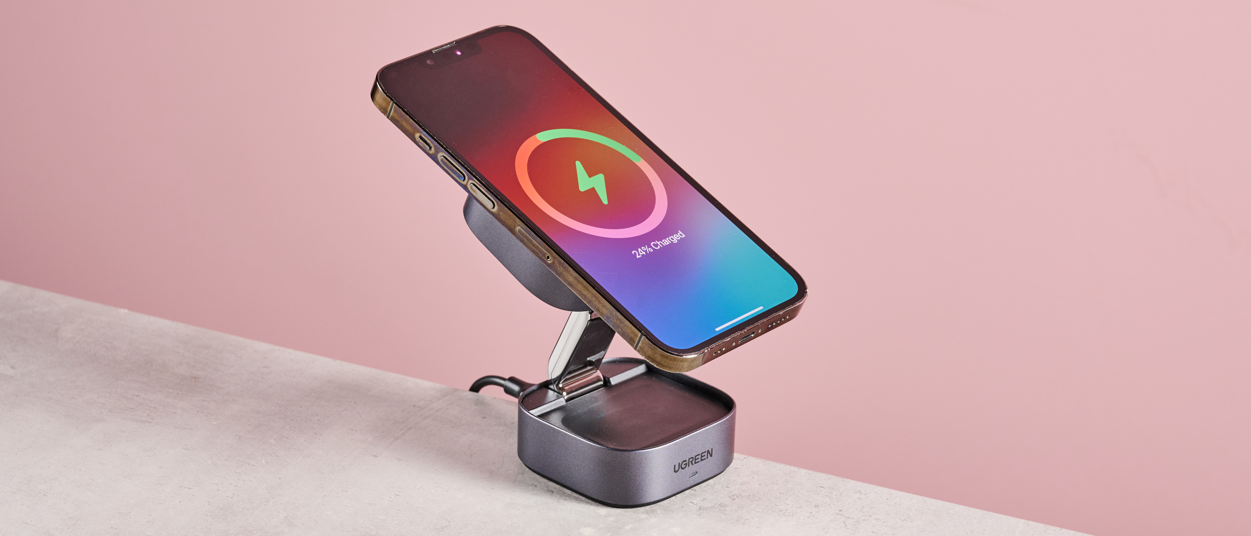The 2-in-1 UGreen charger is folded out into a stand with an iPhone in situ.