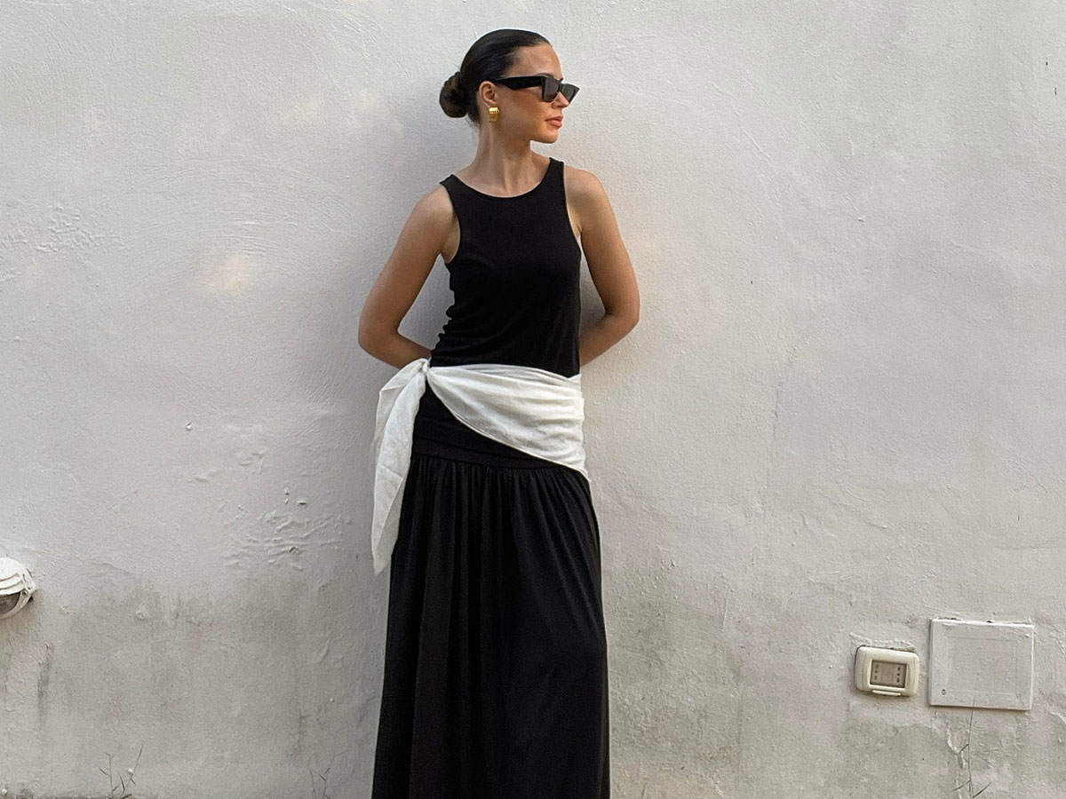@johannapiispa wearing a black tank and skirt with white scarf belt.