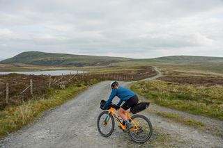 Anna wearing Pearl Izumi’s Quest Convertible Barrier Jacket while riding the Trans Cambrian Way