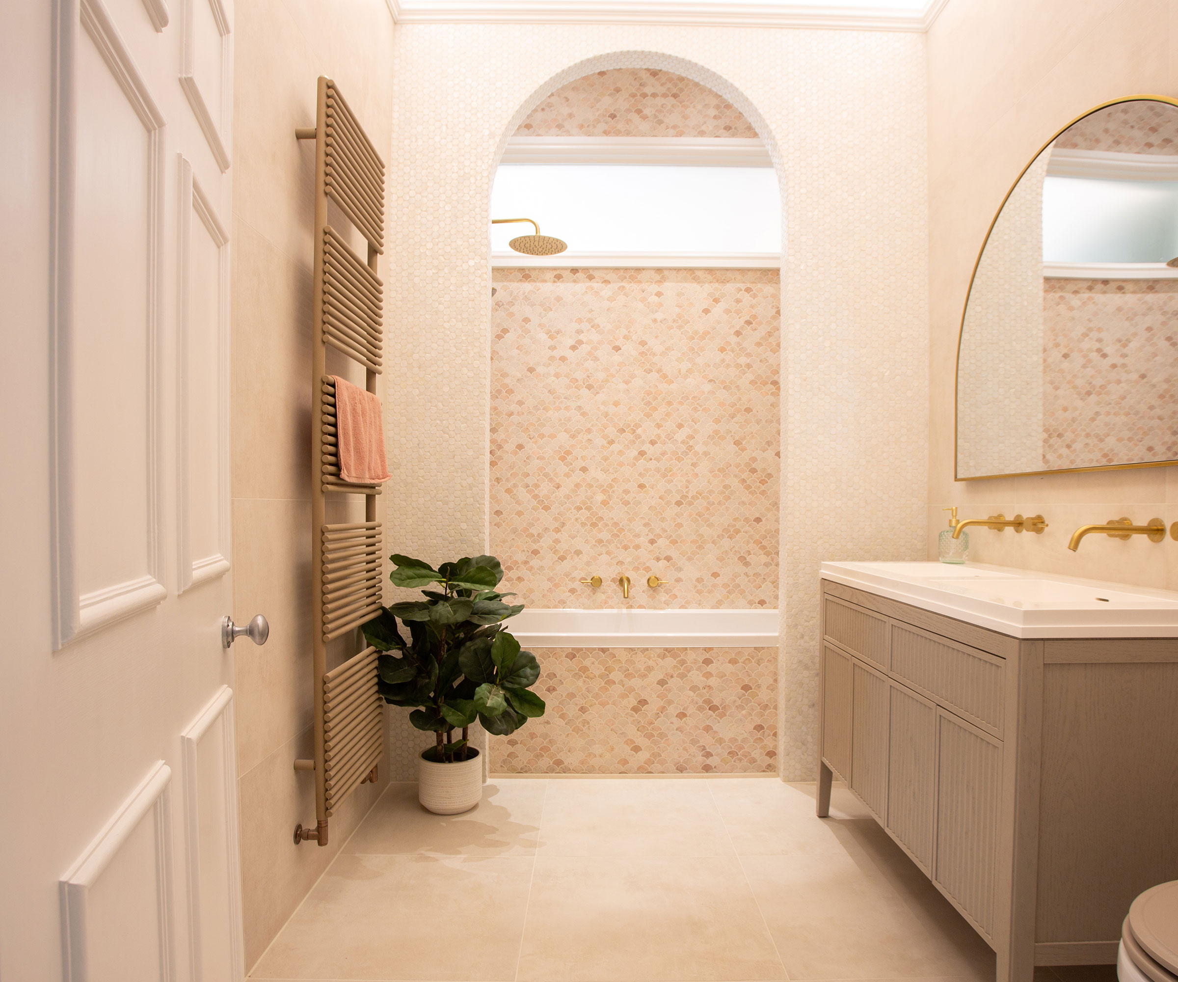 spa-like bathroom with warm neutral tiles