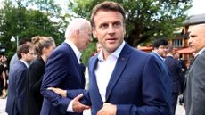 Emmanuel Macron grasps Joe Biden at the 2022 G7 summit in Germany