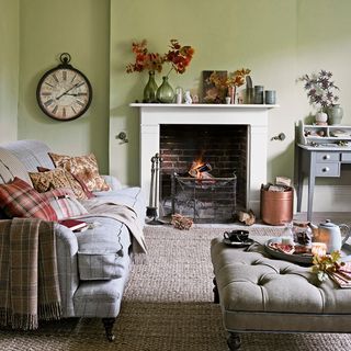 living room with fireplace sofa and wall clock