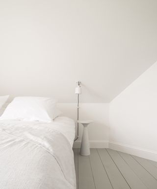 White bedroom with gray floor and crisp white sheets