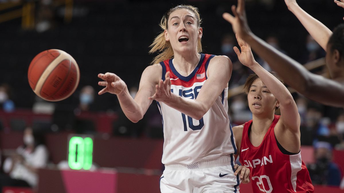 Breanna Stewart, in a Team USA white and red vest, passes the ball during USA vs Japan women&#039;s basketball at the Olympic Games.