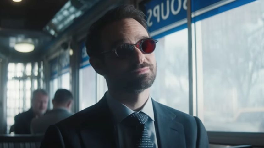 Charlie Cox as Matt Murdock sitting in a diner looking forward. 