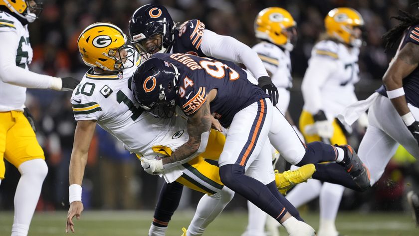 Jordan Love of the Green Bay Packers is hit after his pass by Austin Booker of the Chicago Bears
