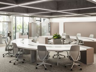 A large circular desk with office chairs