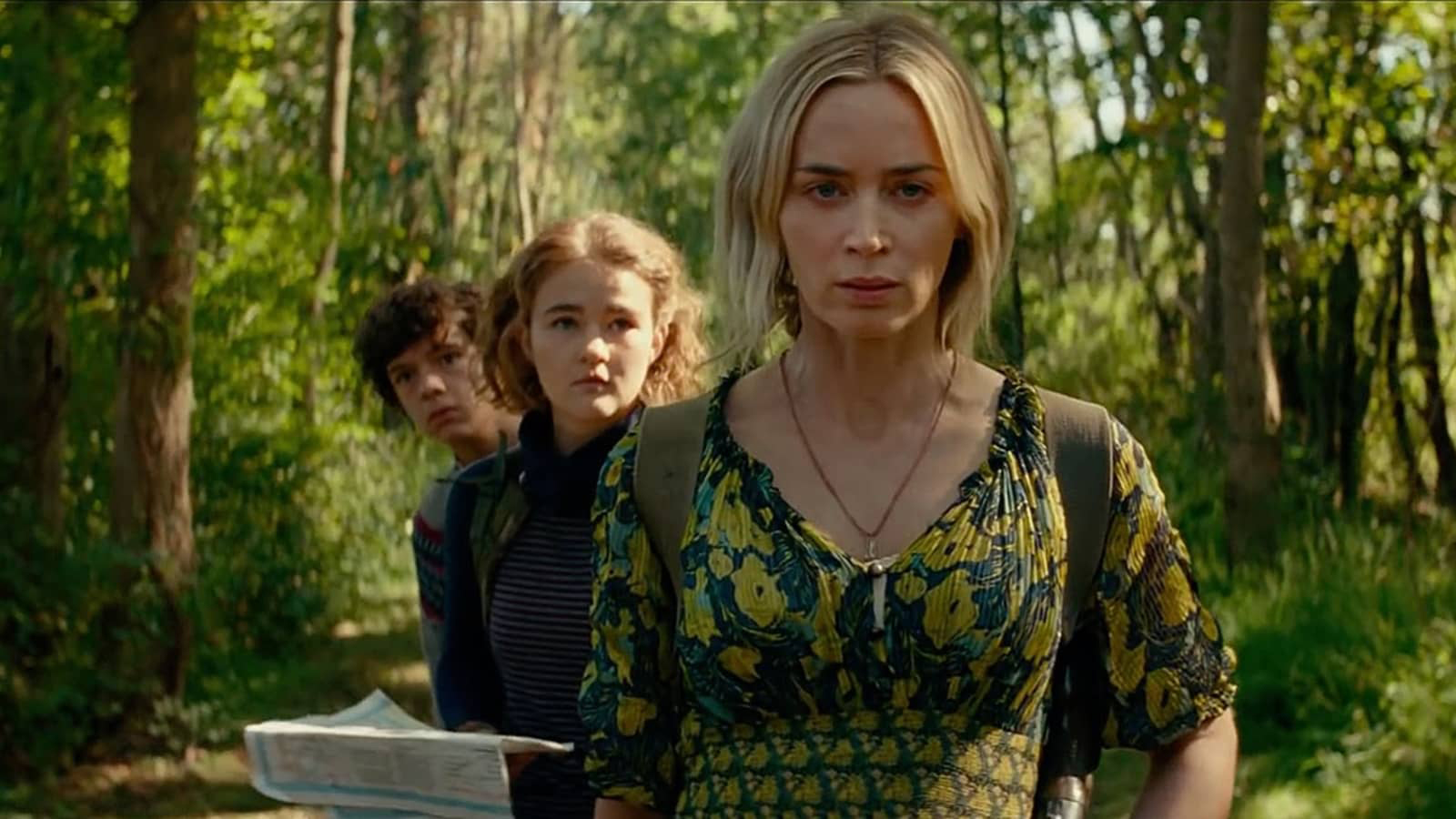 A still from A Quiet Place 2, one of the best new Hulu movies, of Emily Blunt as Evelyn Abbot with her family walking pensively through woods