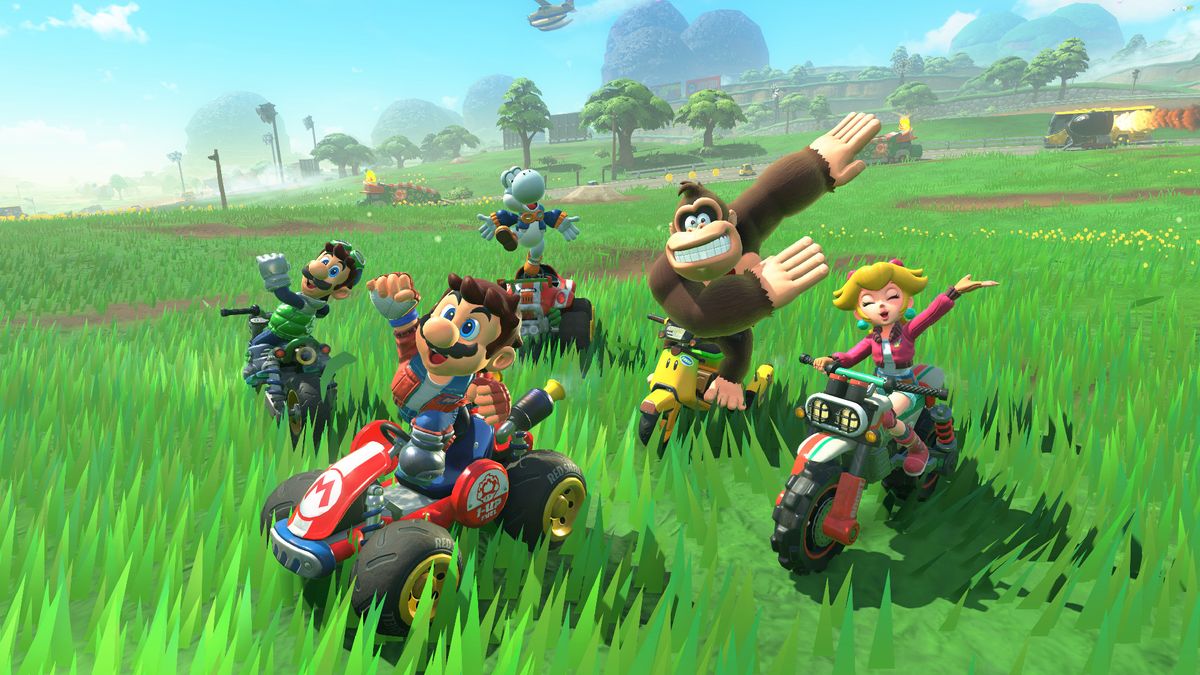 Mario Kart World screenshot showing Mario, Luigi, Peach, and Donkey Kong posing for the camera