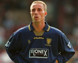 Chris Perry looks on, with his hands on his hips, while playing for Wimbledon against Sheffield Wednesday, 1997