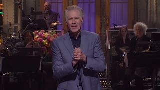 Will Ferrell hosting the Saturday Night Live season finale in 2026. He is wearing a gray suit 