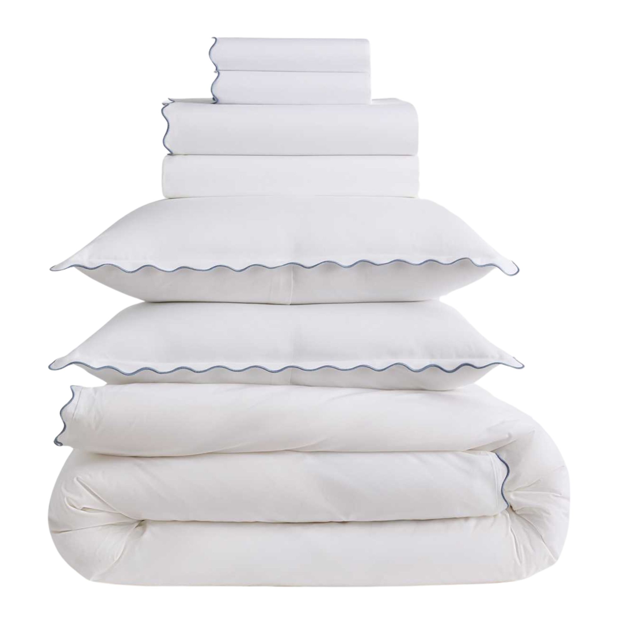 A folded Quince scallop white bedding set