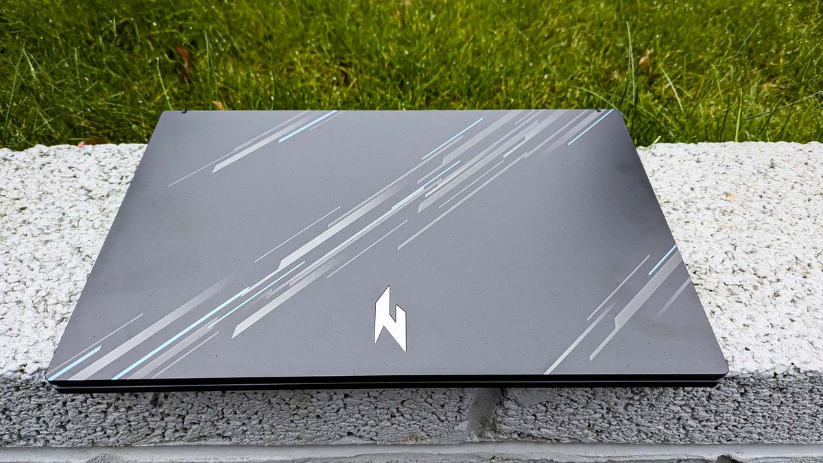 Acer Nitro V 15 with lid closed on wall