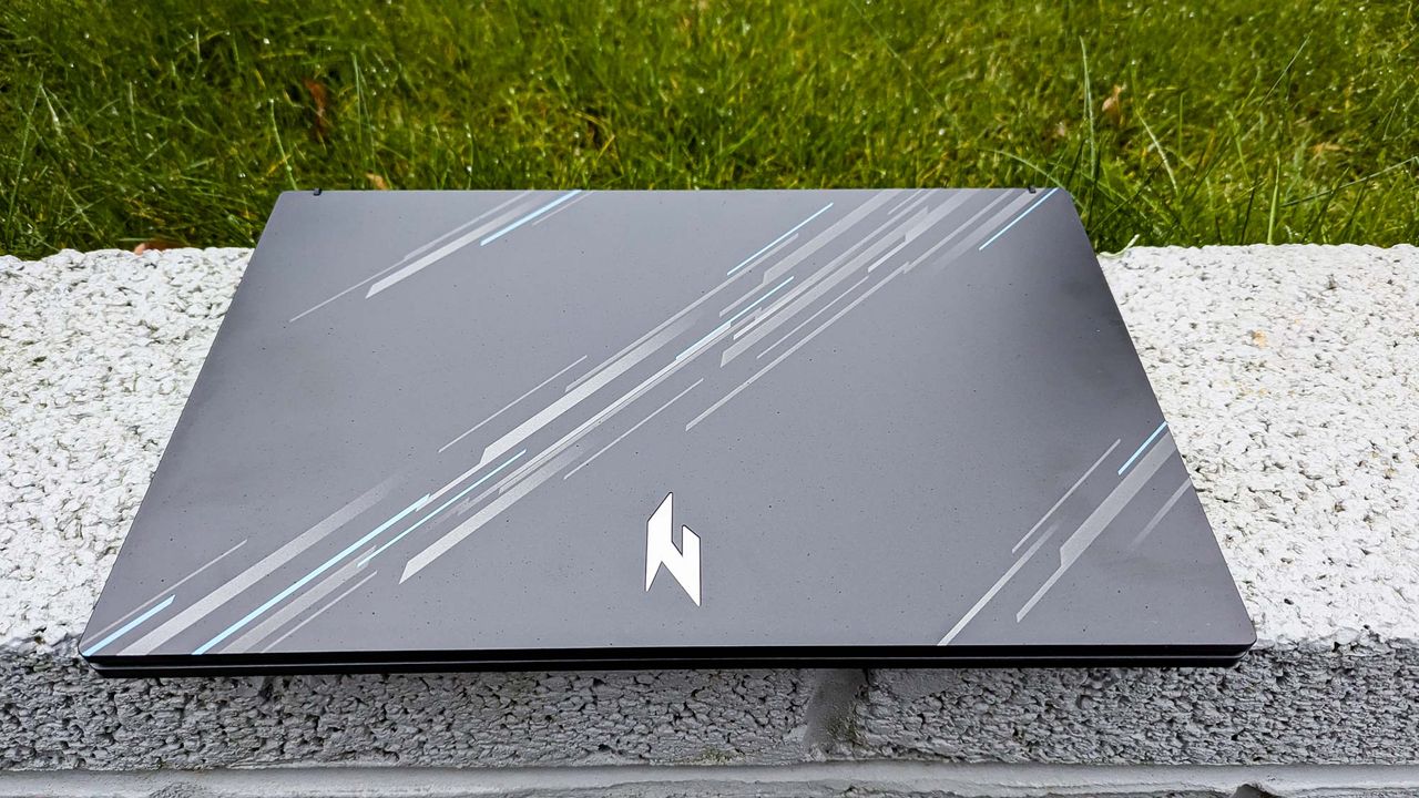 Acer Nitro V 15 with lid closed on wall
