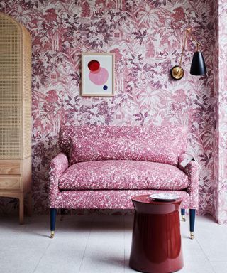 Pink couch and wallpaper, red coffee table, closet