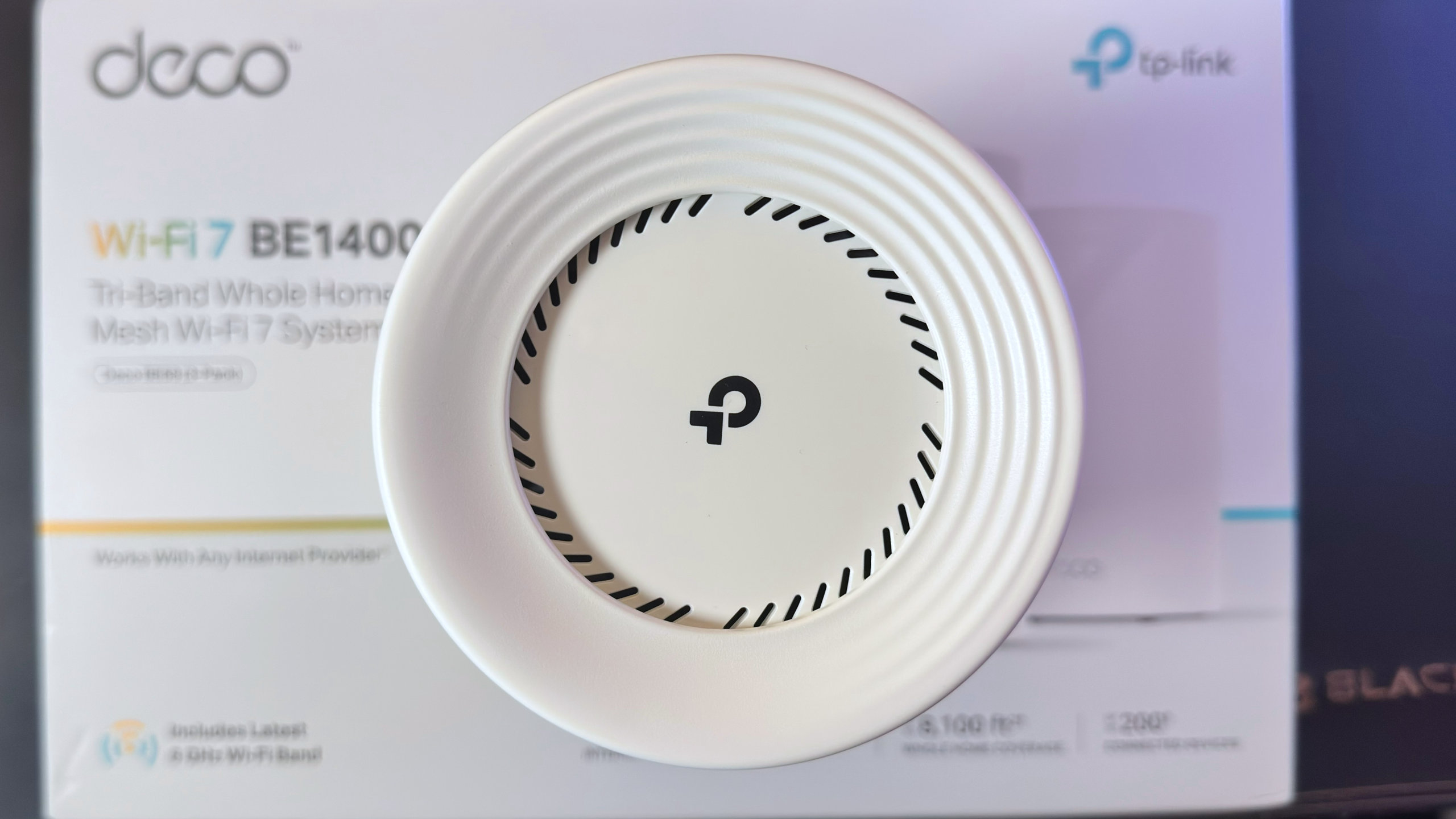 A top-down view of the TP-Link Deco BE68 router.